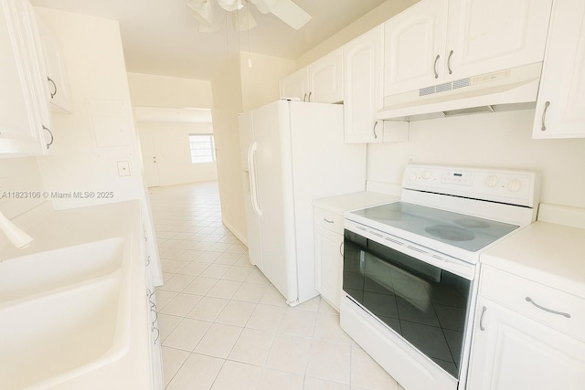 3923 NE 166th St Unit N208, North Miami Beach, FL 33160 - kitchen with white appliances, under cabinet range hood, light tile patterned floors, and light countertops