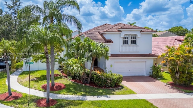 1020 NW 184th Ter, Pembroke Pines, FL 33029 - mediterranean / spanish-style house with a tiled roof, decorative driveway, stucco siding, and an attached garage