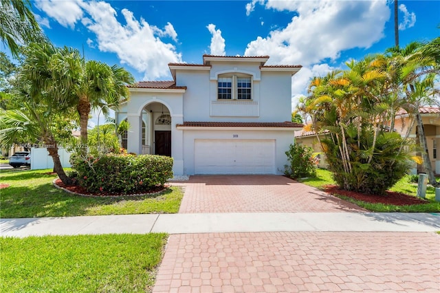 1020 NW 184th Ter, Pembroke Pines, FL 33029 - mediterranean / spanish house with decorative driveway, stucco siding, an attached garage, and a tiled roof