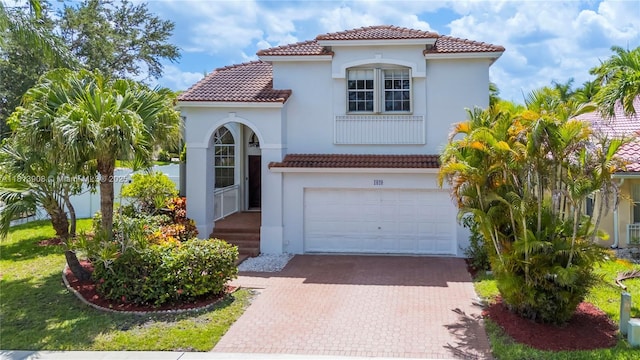 1020 NW 184th Ter, Pembroke Pines, FL 33029 - mediterranean / spanish home with a tiled roof, decorative driveway, an attached garage, and stucco siding