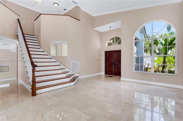 1020 NW 184th Ter, Pembroke Pines, FL 33029 - entryway featuring a towering ceiling, ornamental molding, stairway, and marble tiled floors