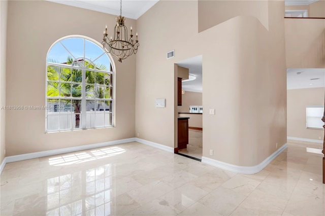 1020 NW 184th Ter, Pembroke Pines, FL 33029 - spare room with light marble finish floors, a chandelier, a high ceiling, and ornamental molding