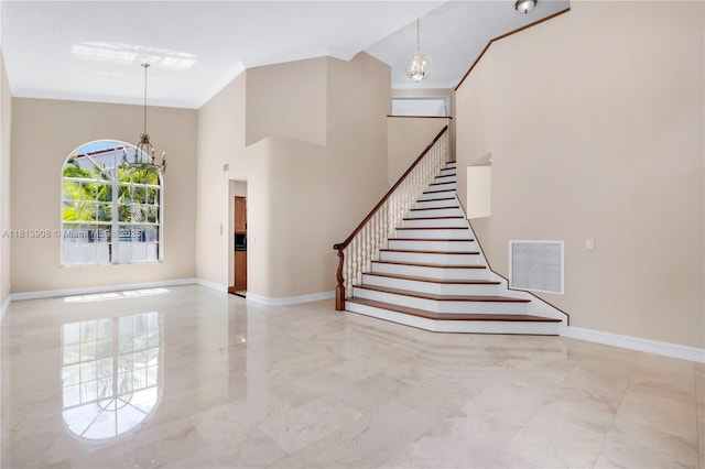 1020 NW 184th Ter, Pembroke Pines, FL 33029 - stairs with a chandelier, marble tiled flooring, ornamental molding, and a high ceiling