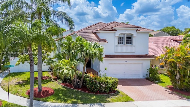 1020 NW 184th Ter, Pembroke Pines, FL 33029 - mediterranean / spanish house with a tiled roof, decorative driveway, a garage, stucco siding, and a front lawn