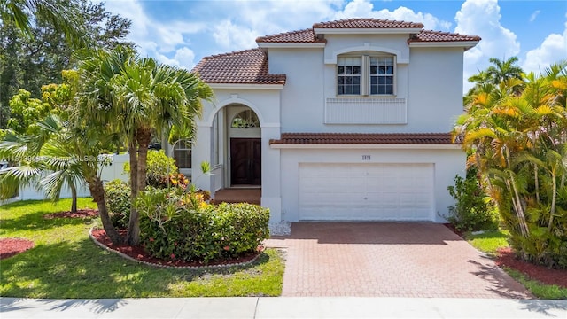 1020 NW 184th Ter, Pembroke Pines, FL 33029 - mediterranean / spanish house featuring a garage, decorative driveway, a tiled roof, and stucco siding