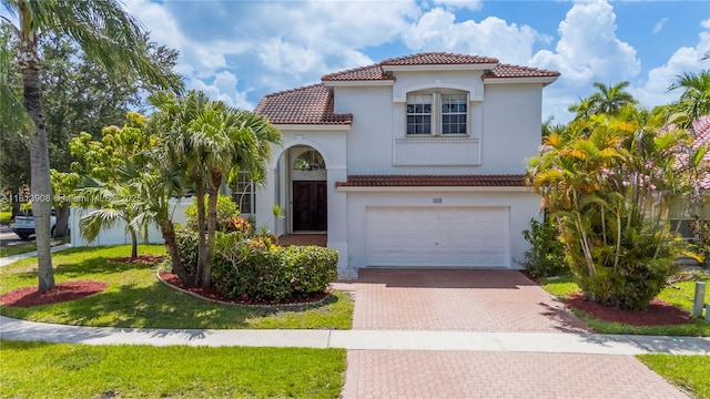 1020 NW 184th Ter, Pembroke Pines, FL 33029 - mediterranean / spanish home featuring a tiled roof, decorative driveway, a garage, stucco siding, and a front lawn