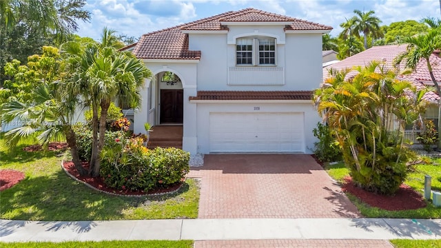 1020 NW 184th Ter, Pembroke Pines, FL 33029 - mediterranean / spanish-style house featuring a tile roof, decorative driveway, an attached garage, and stucco siding