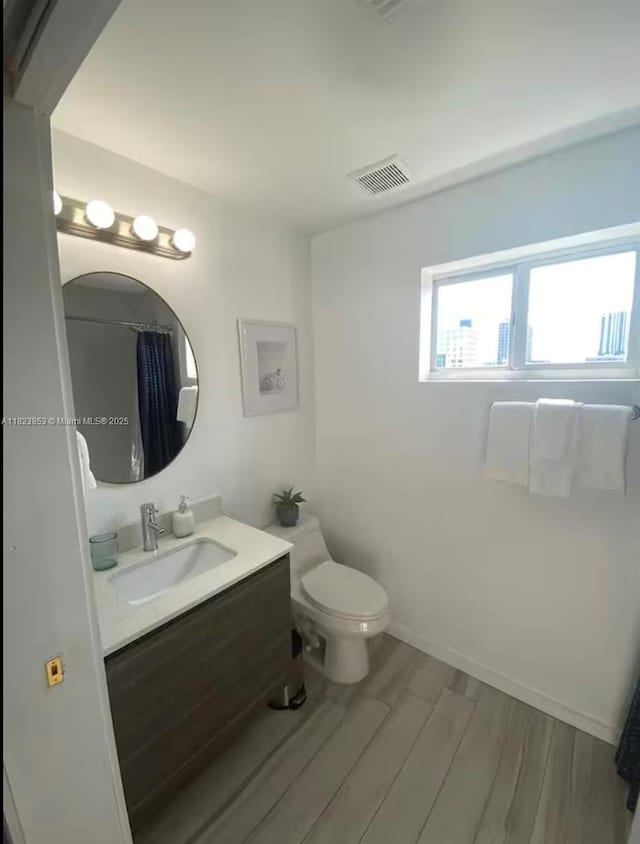 481 NE 29th St Unit 706, Miami, FL 33137 - full bathroom featuring vanity, wood finished floors, and a shower with curtain