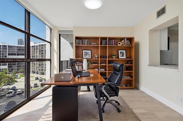 600 Parkview Dr Unit 624, Hallandale Beach, FL 33009 - home office with wood finished floors, a wall of windows, and a city view