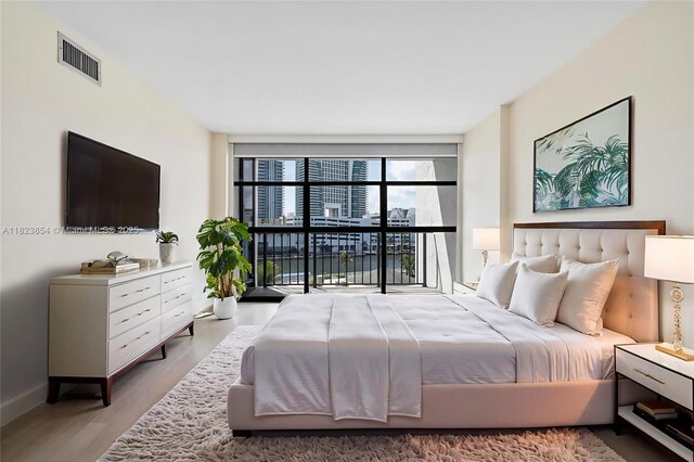 600 Parkview Dr Unit 624, Hallandale Beach, FL 33009 - bedroom featuring wood finished floors and floor to ceiling windows