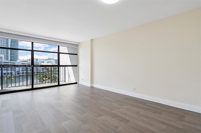 600 Parkview Dr Unit 624, Hallandale Beach, FL 33009 - spare room featuring wood finished floors and a wall of windows