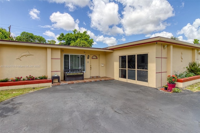 6530 NW 29th St, Sunrise, FL 33313 - view of exterior entry with stucco siding and a patio area