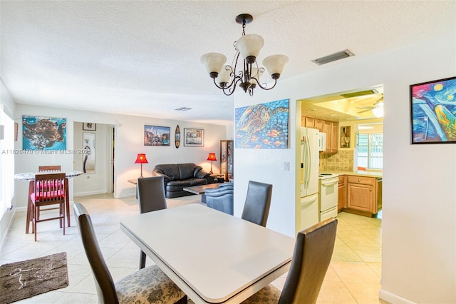 6530 NW 29th St, Sunrise, FL 33313 - dining room featuring light tile patterned floors, a textured ceiling, a chandelier, and a ceiling fan