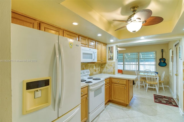 6530 NW 29th St, Sunrise, FL 33313 - kitchen with white appliances, light countertops, decorative backsplash, a peninsula, and a ceiling fan