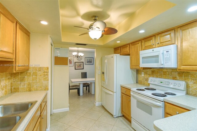 6530 NW 29th St, Sunrise, FL 33313 - kitchen with white appliances, light tile patterned floors, a chandelier, light countertops, and a ceiling fan