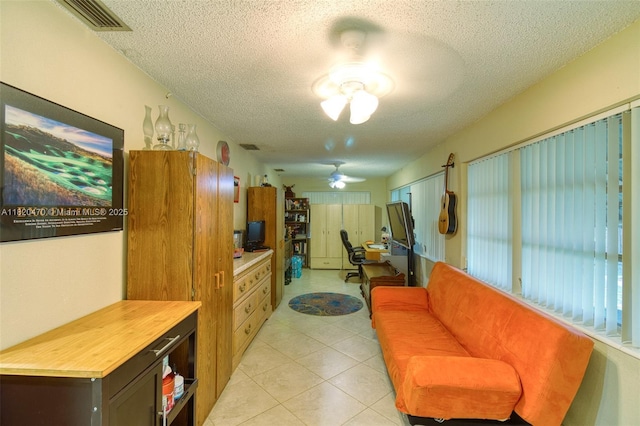 6530 NW 29th St, Sunrise, FL 33313 - living area featuring a textured ceiling, ceiling fan, and light tile patterned flooring