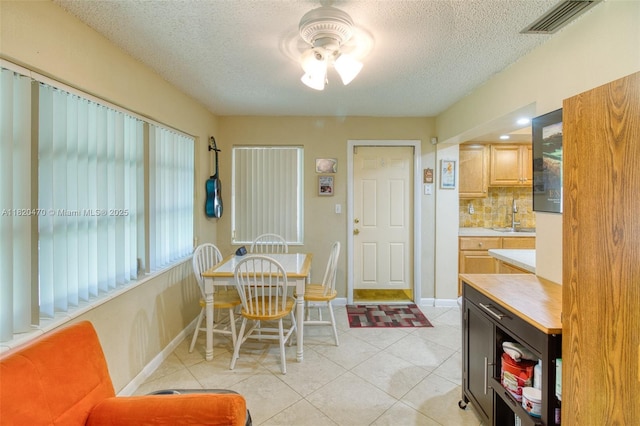 6530 NW 29th St, Sunrise, FL 33313 - dining room featuring a textured ceiling, light tile patterned floors, and a ceiling fan