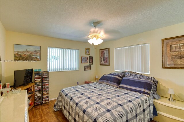 6530 NW 29th St, Sunrise, FL 33313 - bedroom featuring wood finished floors, a ceiling fan, and a textured ceiling
