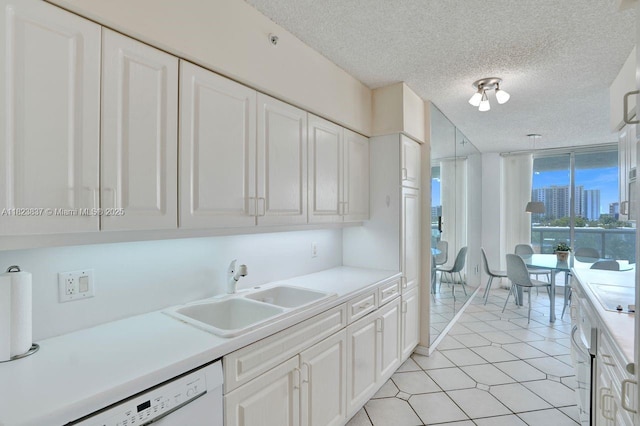 16400 Collins Ave Unit 544, Sunny Isles Beach, FL 33160 - kitchen with white dishwasher, white cabinets, light countertops, a textured ceiling, and a wall of windows