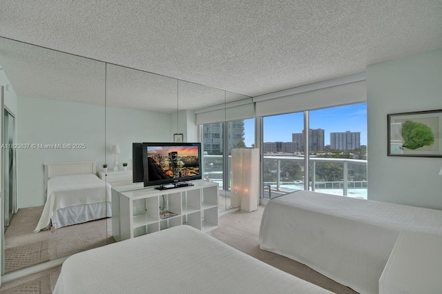 16400 Collins Ave Unit 544, Sunny Isles Beach, FL 33160 - bedroom with light carpet, a textured ceiling, and access to exterior
