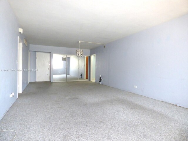 5005 Collins Ave Unit 202, Miami Beach, FL 33140 - carpeted spare room with a chandelier