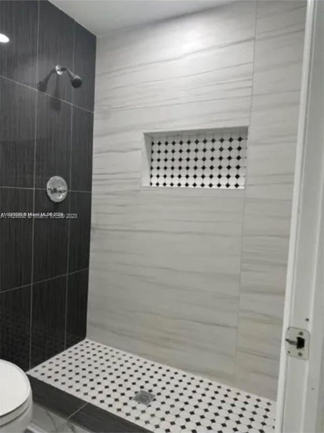 9860 SW 161st Ave, Miami, FL 33196 - bathroom featuring a tile shower and marble look tiles