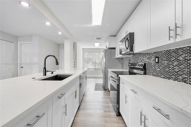 8239 NW 8th St Unit 3, Plantation, FL 33324 - kitchen with electric stove, black microwave, recessed lighting, stainless steel dishwasher, and backsplash