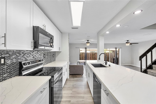 8239 NW 8th St Unit 3, Plantation, FL 33324 - kitchen with appliances with stainless steel finishes, recessed lighting, a ceiling fan, backsplash, and light stone countertops