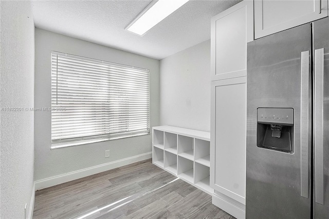 8239 NW 8th St Unit 3, Plantation, FL 33324 - mudroom with light wood finished floors and a textured ceiling