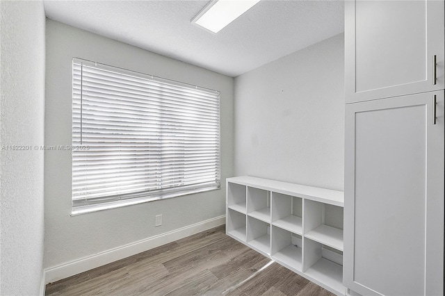 8239 NW 8th St Unit 3, Plantation, FL 33324 - mudroom featuring wood finished floors and a textured ceiling