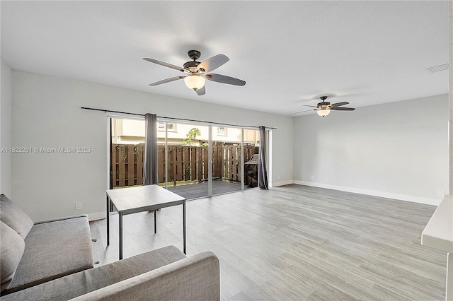 8239 NW 8th St Unit 3, Plantation, FL 33324 - unfurnished living room featuring a ceiling fan and light wood-style floors