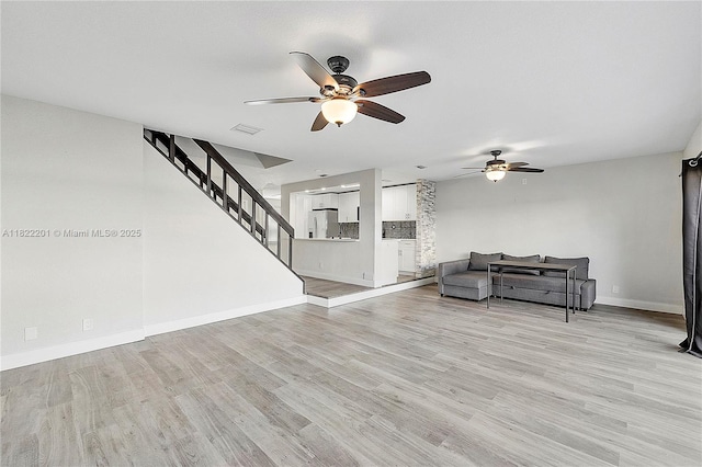 8239 NW 8th St Unit 3, Plantation, FL 33324 - living room featuring a ceiling fan, stairway, and light wood-style floors