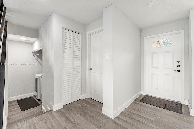 8239 NW 8th St Unit 3, Plantation, FL 33324 - foyer entrance with independent washer and dryer and wood finished floors