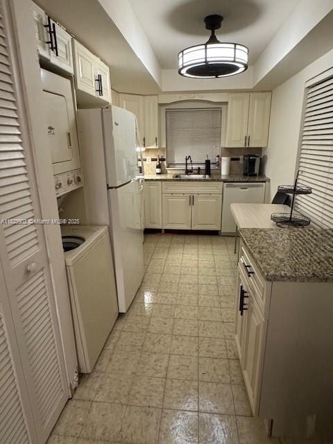 13648 Coconut Palm Ct Unit C, Delray Beach, FL 33484 - kitchen featuring dishwasher, a raised ceiling, light stone counters, and freestanding refrigerator