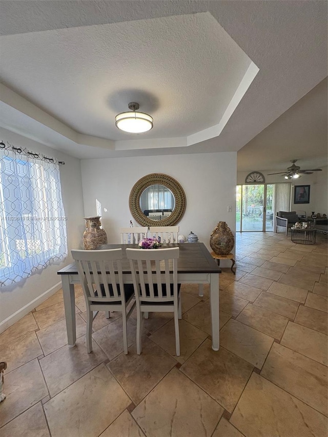 13933 SW 155th Ct, Miami, FL 33196 - dining room featuring a textured ceiling, a raised ceiling, and ceiling fan