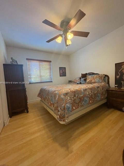 13933 SW 155th Ct, Miami, FL 33196 - bedroom with light wood-type flooring and ceiling fan
