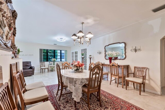 9064 Garland Ave, Surfside, FL 33154 - dining area featuring a chandelier and light tile patterned flooring