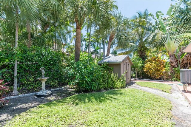 9064 Garland Ave, Surfside, FL 33154 - view of grassy yard featuring a shed