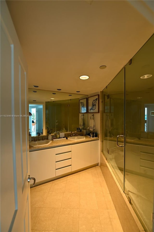 2127 Brickell Ave Unit 1005, Miami, FL 33129 - bathroom with double vanity, a shower with door, a tub, recessed lighting, and tile patterned floors