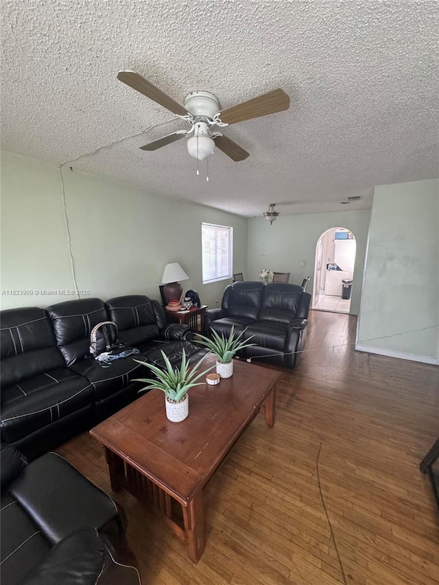 6413 Franklin St, Hollywood, FL 33024 - living room featuring arched walkways, hardwood / wood-style floors, a textured ceiling, and ceiling fan