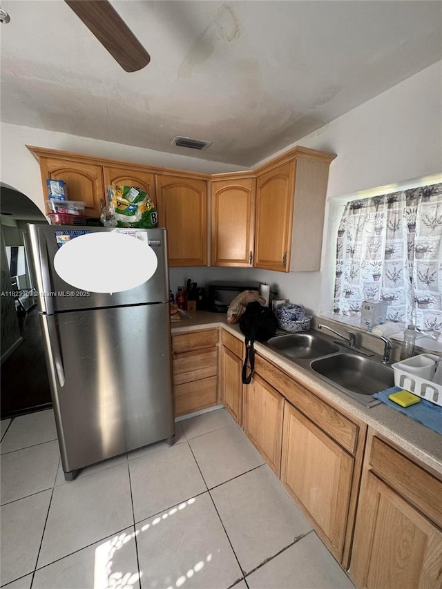 6413 Franklin St, Hollywood, FL 33024 - kitchen with freestanding refrigerator, light tile patterned floors, light countertops, and brown cabinetry