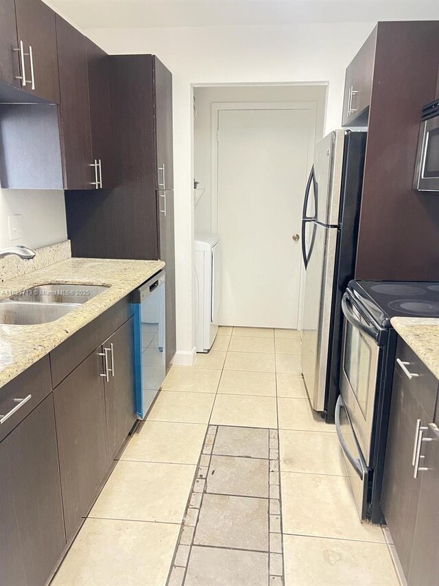 4017 NW 87th Ave Unit 4017, Sunrise, FL 33351 - kitchen featuring stainless steel appliances, light tile patterned floors, dark brown cabinets, and washer / clothes dryer