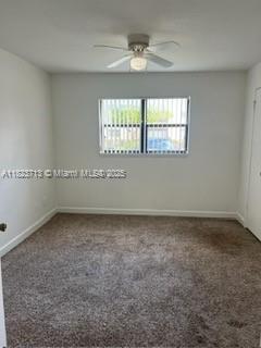 4017 NW 87th Ave Unit 4017, Sunrise, FL 33351 - carpeted empty room featuring baseboards and ceiling fan