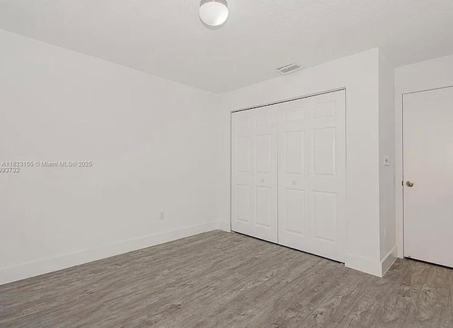 9720 SW 154th Pl, Miami, FL 33196 - unfurnished bedroom with wood finished floors and a closet