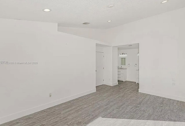9720 SW 154th Pl, Miami, FL 33196 - empty room featuring wood finished floors, recessed lighting, and vaulted ceiling
