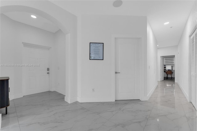 4445 SW 160th Ave Unit 102, Miramar, FL 33027 - corridor featuring light marble finish flooring, arched walkways, and recessed lighting