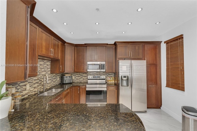 4445 SW 160th Ave Unit 102, Miramar, FL 33027 - kitchen with stainless steel appliances, recessed lighting, backsplash, light marble finish floors, and dark stone counters