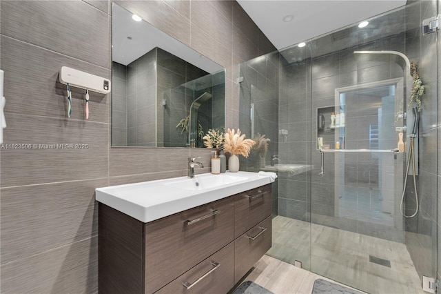4445 SW 160th Ave Unit 102, Miramar, FL 33027 - bathroom with tile walls, vanity, and a shower stall