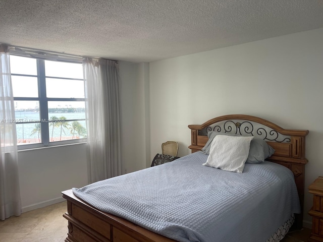 5 Island Ave Unit 5G, Miami Beach, FL 33139 - bedroom with a textured ceiling and baseboards