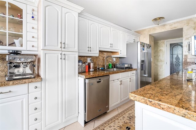 250 174th St Unit 1704, Sunny Isles Beach, FL 33160 - kitchen featuring stainless steel appliances, tasteful backsplash, light tile patterned floors, white cabinets, and crown molding